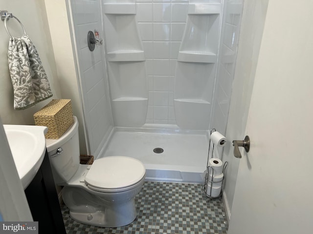 full bath with a stall shower, vanity, and toilet