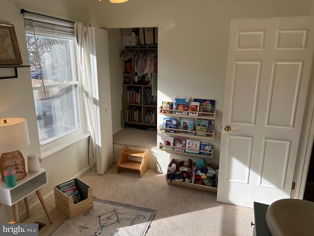 playroom featuring carpet flooring and baseboards