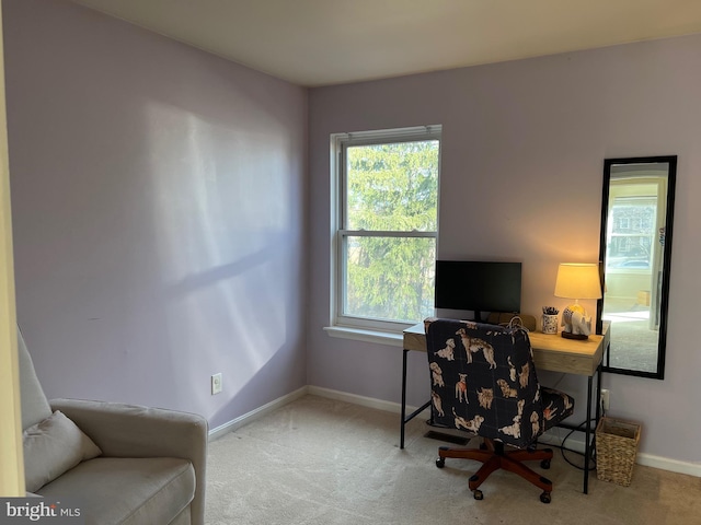 carpeted home office featuring baseboards