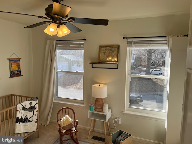 carpeted bedroom featuring visible vents, ceiling fan, a crib, and baseboards