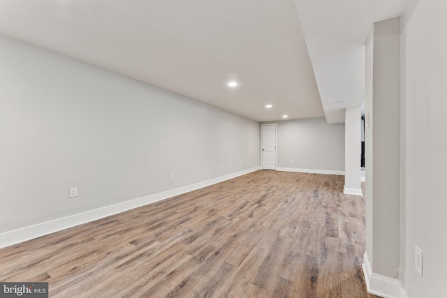 unfurnished living room featuring recessed lighting, light wood-type flooring, and baseboards