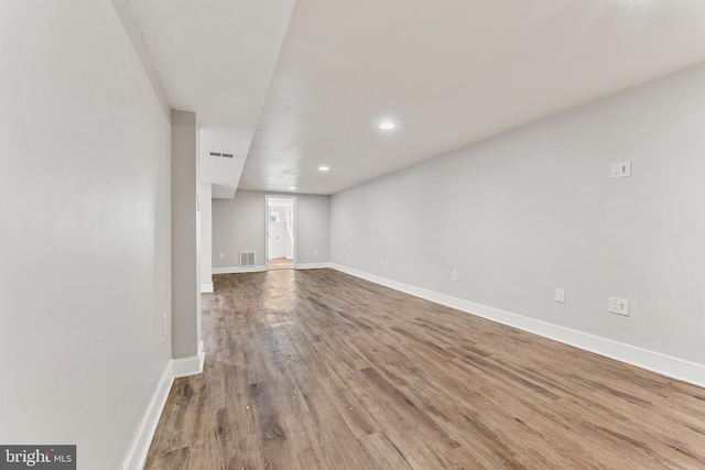 below grade area with baseboards, visible vents, wood finished floors, and recessed lighting