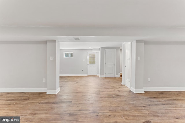 empty room featuring light wood-style flooring and baseboards