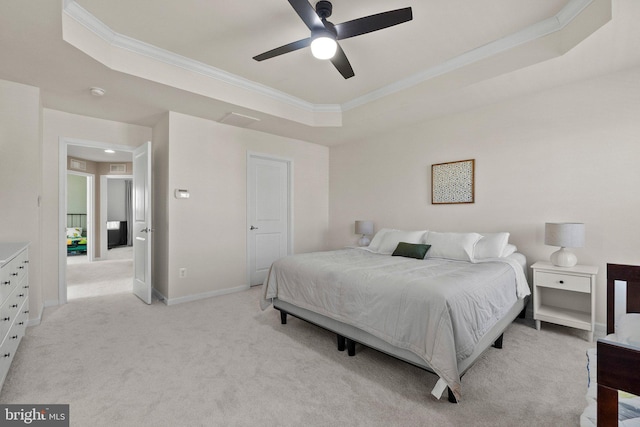 bedroom featuring ceiling fan, light carpet, baseboards, a tray ceiling, and crown molding