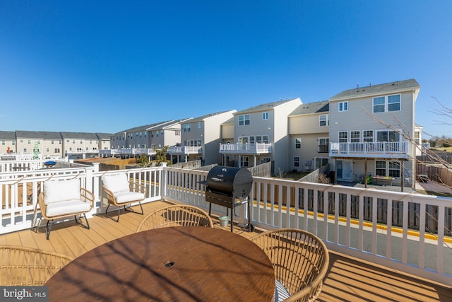 deck featuring area for grilling and a residential view