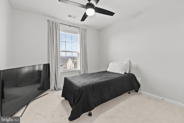 carpeted bedroom featuring visible vents, baseboards, and ceiling fan