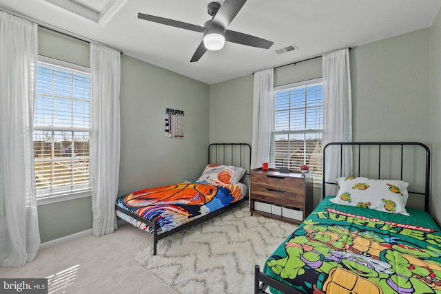 bedroom with baseboards, carpet, visible vents, and a ceiling fan