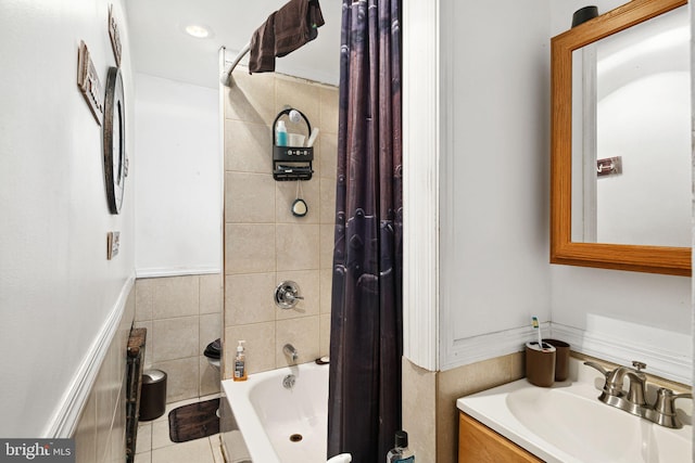 full bath featuring shower / bath combo with shower curtain, vanity, and tile patterned floors