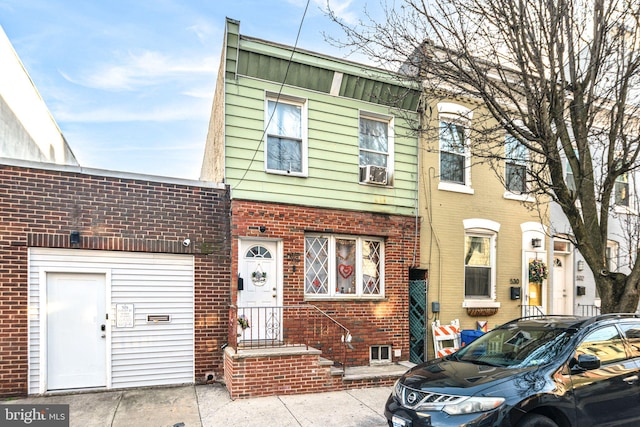 townhome / multi-family property with brick siding