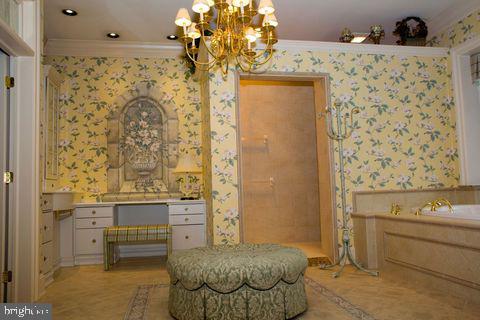 living area with crown molding and wallpapered walls