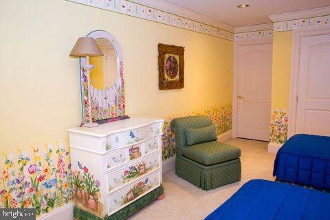 bedroom with carpet floors and crown molding