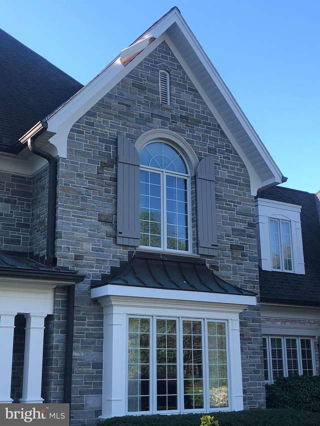 view of home's exterior with metal roof, a standing seam roof, and roof with shingles