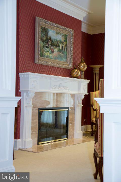 room details with ornamental molding, a tile fireplace, and wallpapered walls