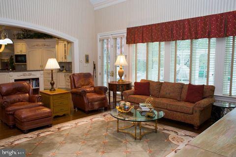 living area with a fireplace and wallpapered walls