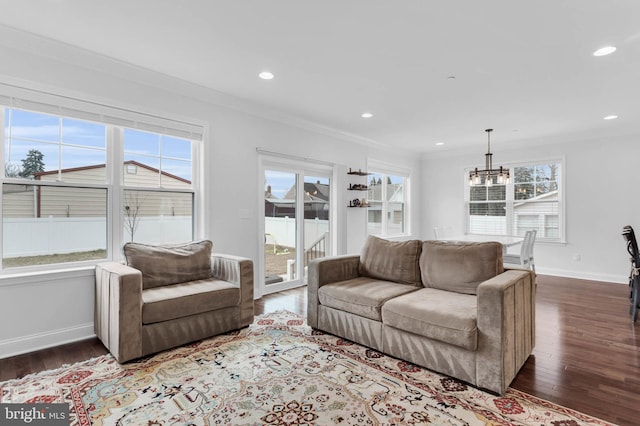 living area with baseboards, dark wood-type flooring, crown molding, and recessed lighting