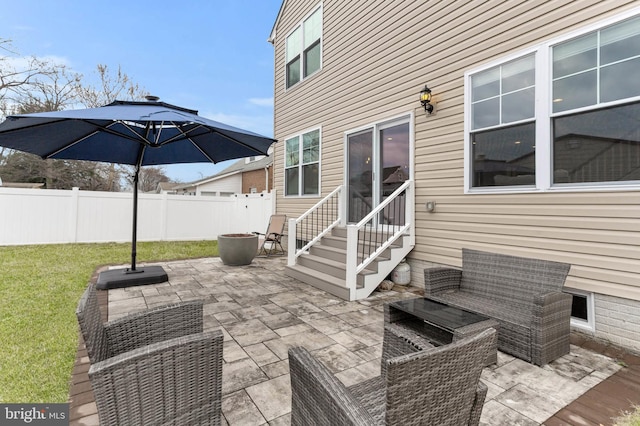 view of patio with entry steps, an outdoor hangout area, and fence