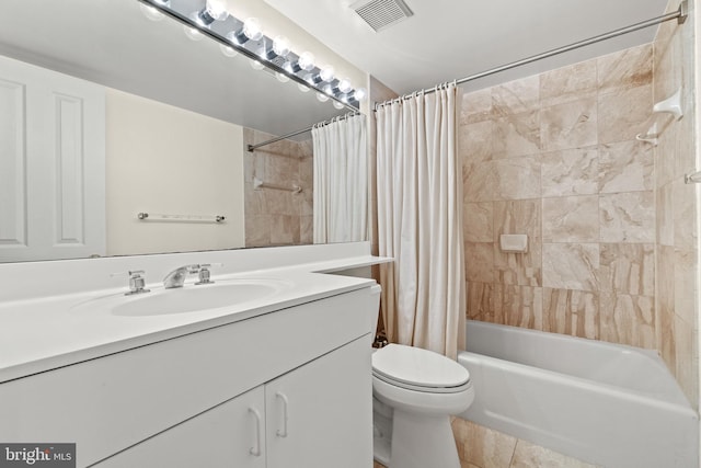 bathroom with vanity, visible vents, tile patterned flooring, shower / bath combination with curtain, and toilet