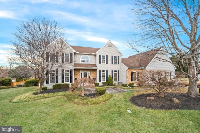 view of front of house with stone siding and a front yard