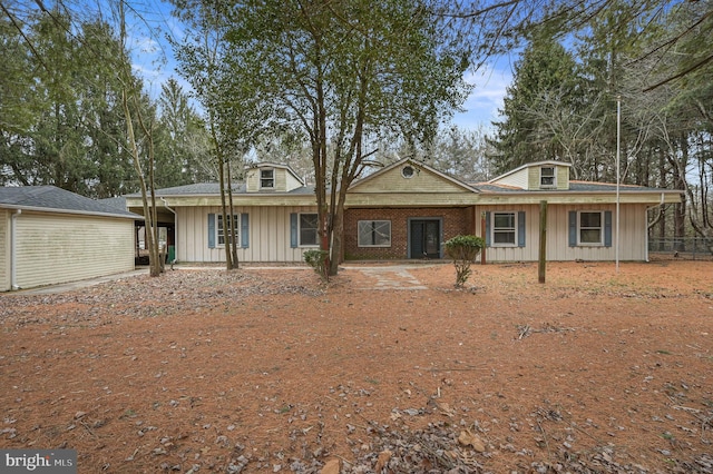 view of front facade with brick siding and board and batten siding