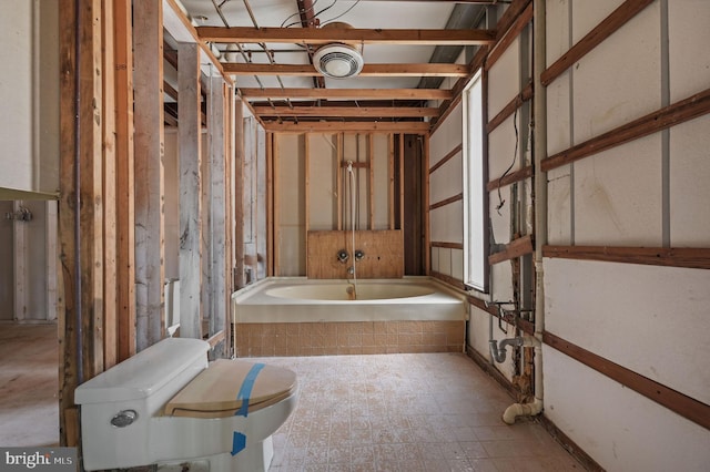 bathroom featuring toilet and a bath