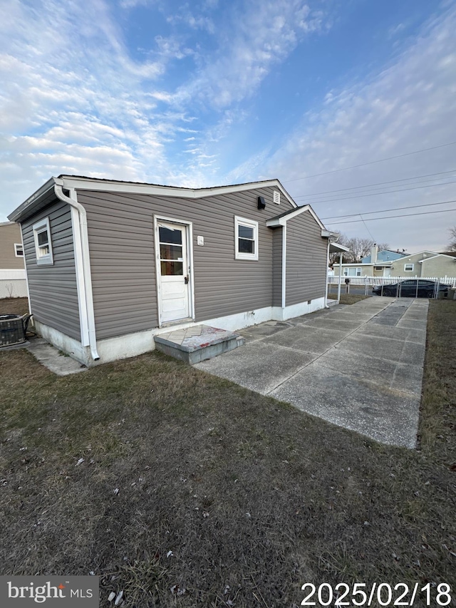 view of outbuilding with central AC and fence