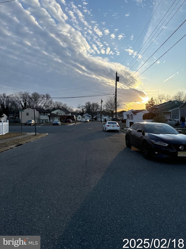 view of road with a residential view and sidewalks