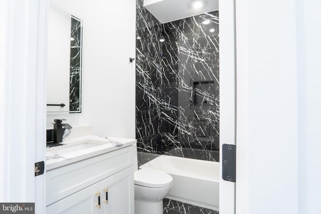 bathroom with toilet, shower / bath combination, and vanity