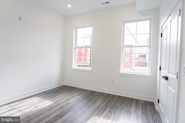 spare room with light wood-style floors, recessed lighting, visible vents, and baseboards