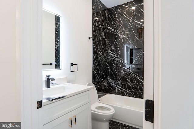 bathroom with tub / shower combination, vanity, and toilet