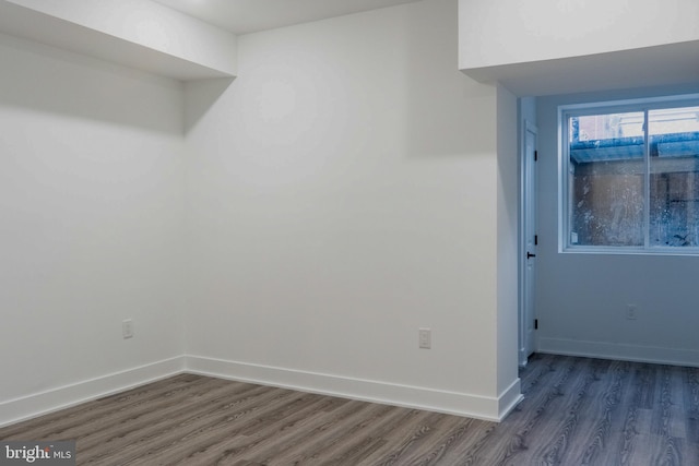 interior space featuring baseboards and dark wood-type flooring