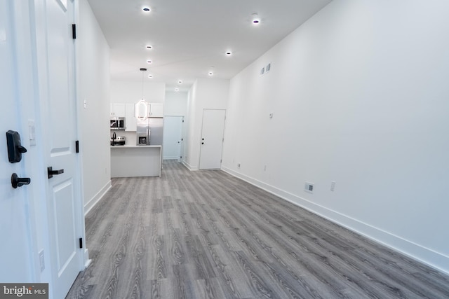 interior space with recessed lighting, baseboards, visible vents, and light wood finished floors