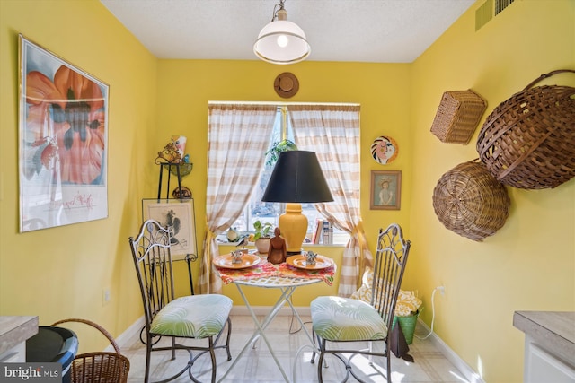 sitting room featuring tile patterned floors, visible vents, and baseboards