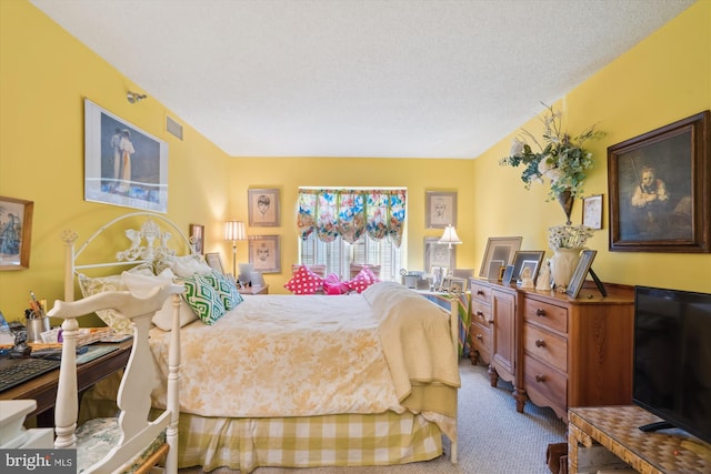 carpeted bedroom featuring visible vents and a textured ceiling