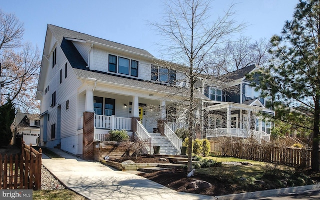 view of front of home featuring covered porch, concrete driveway, roof with shingles, and fence