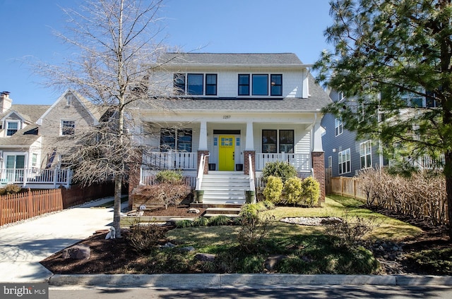 view of front of property featuring covered porch, driveway, roof with shingles, and fence