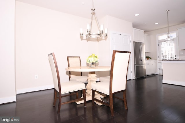 dining area featuring dark wood-style floors, recessed lighting, baseboards, and a notable chandelier