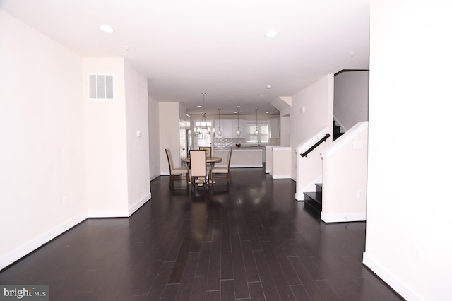 corridor with recessed lighting, visible vents, dark wood finished floors, and stairs