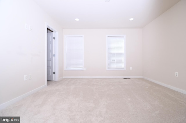 unfurnished room with light carpet, baseboards, and recessed lighting