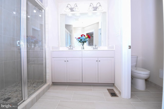 bathroom featuring a stall shower, visible vents, a sink, and toilet