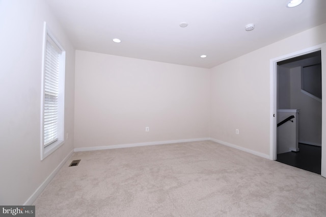 unfurnished bedroom featuring recessed lighting, visible vents, light carpet, and baseboards