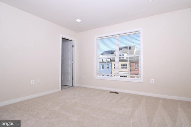 unfurnished room featuring light carpet, recessed lighting, visible vents, and baseboards