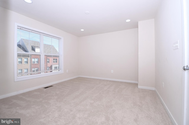 unfurnished room featuring light carpet, recessed lighting, visible vents, and baseboards