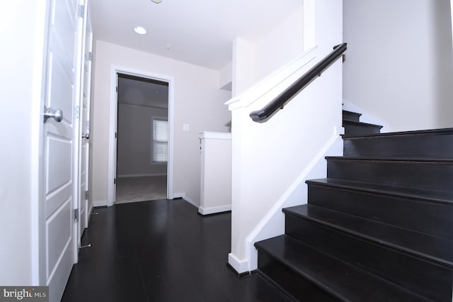 staircase with recessed lighting, wood finished floors, and baseboards