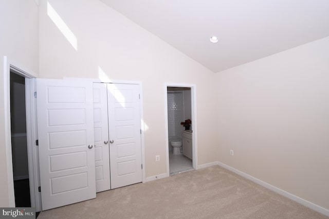 unfurnished bedroom with recessed lighting, a closet, light carpet, connected bathroom, and baseboards