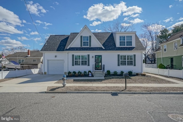 view of front facade featuring a garage, driveway, fence, and roof with shingles