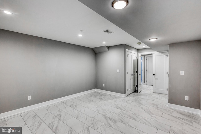 empty room featuring recessed lighting, marble finish floor, visible vents, and baseboards