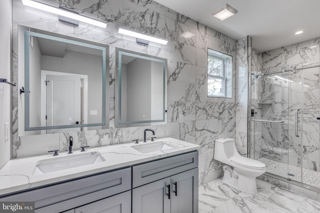 bathroom featuring a marble finish shower, a sink, toilet, and double vanity