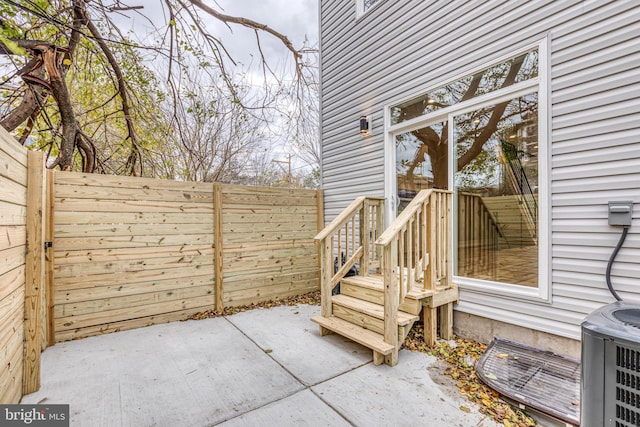 view of patio / terrace with fence and central air condition unit