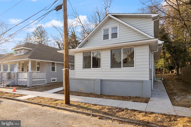 view of front of property with a porch and a shingled roof