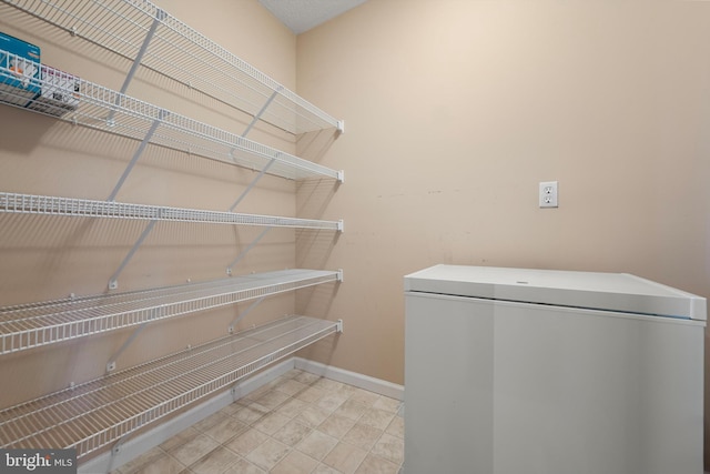 laundry area with baseboards